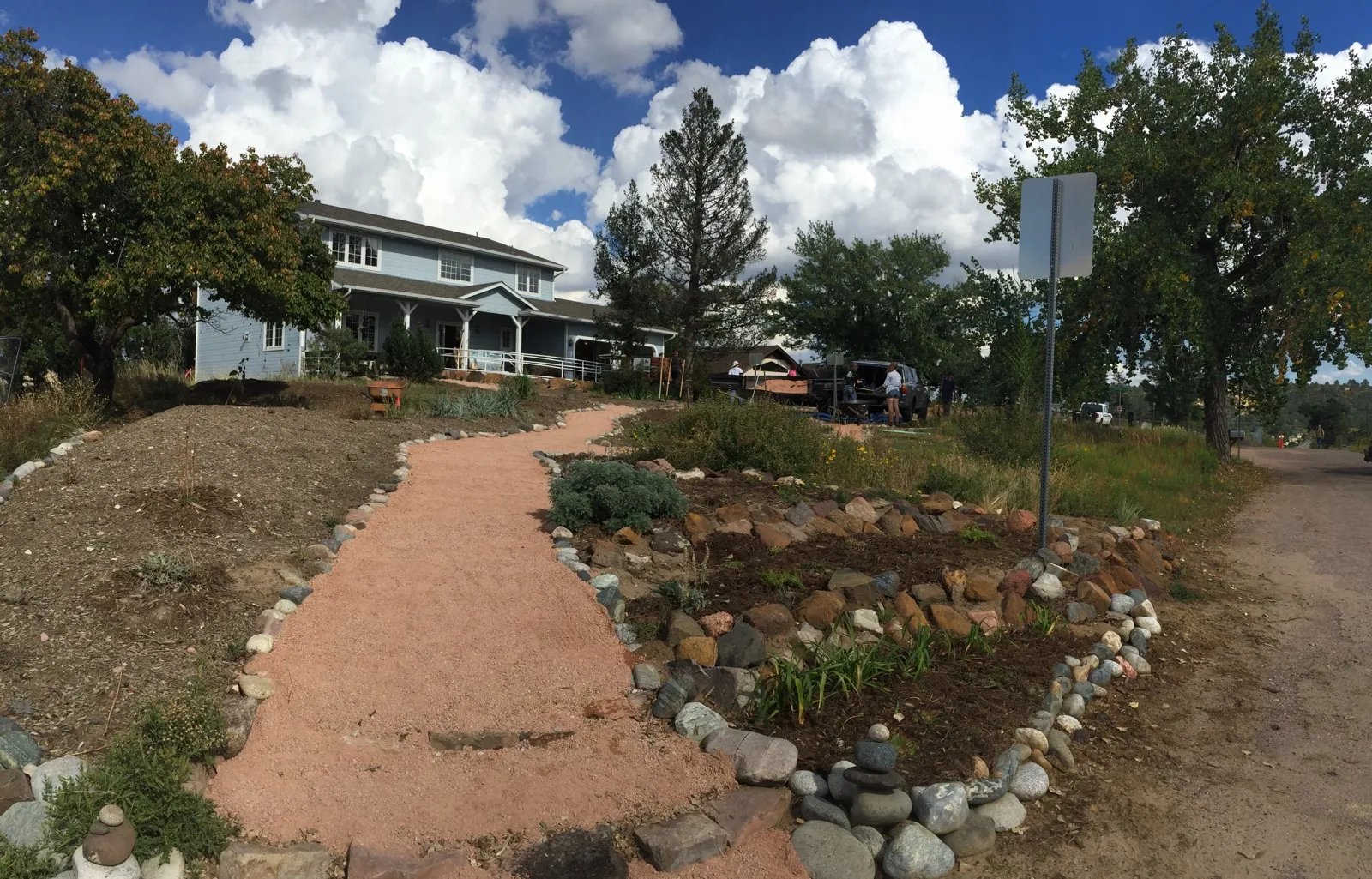 residential blue house with limited plantings