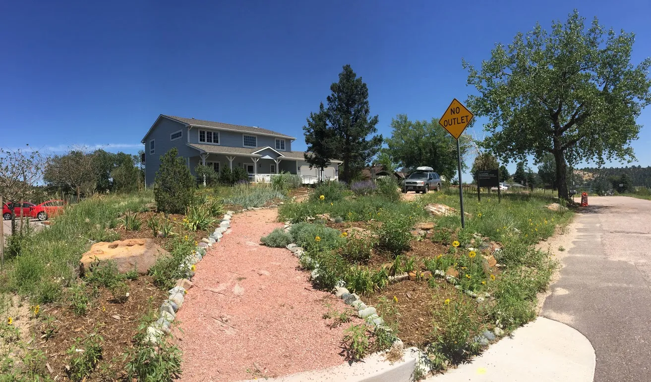 residential blue house with plantings