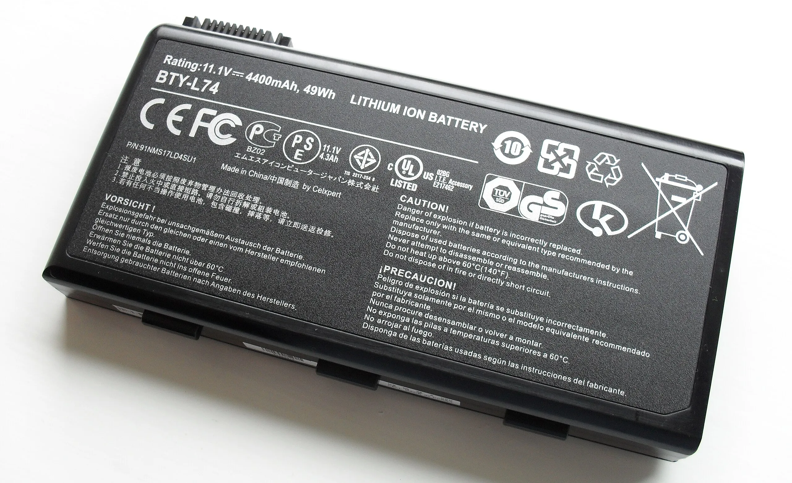 Lithium-ion laptop battery removed from a computer, showing the battery pack and label.