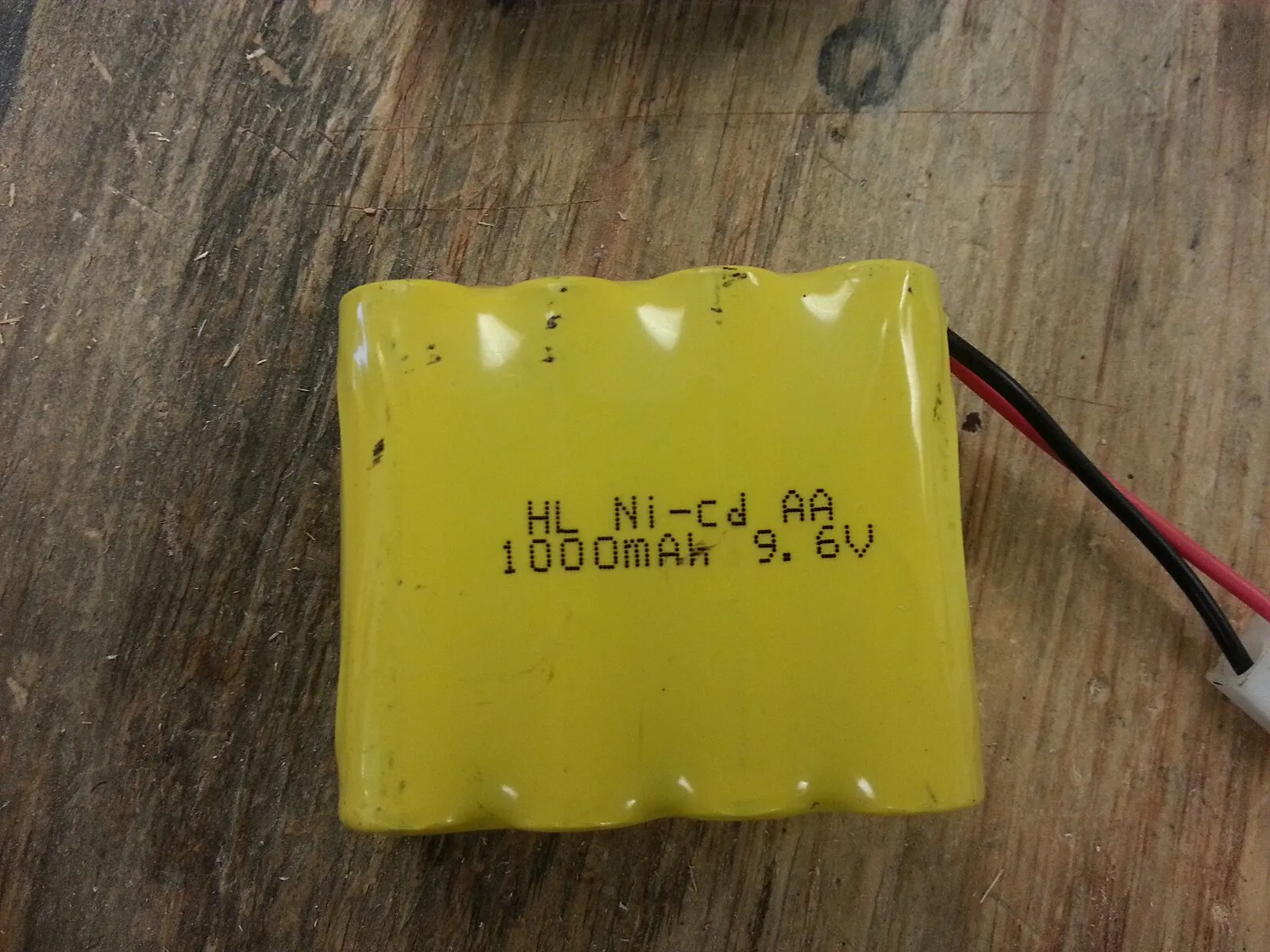 Nickel-cadmium rechargeable battery modules on a wooden surface.